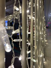 Close-up of illuminated lighting equipment hanging at night