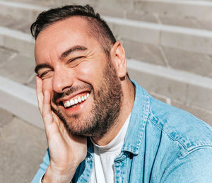 Portrait of a handsome hipster man in a jean jacket. a man in a big city on the street, a life style 