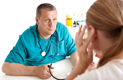 Nurse examining patient in hospital