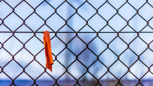 Close-up of chainlink fence against sky