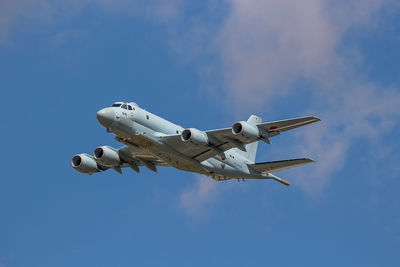 Low angle view of airplane flying in sky