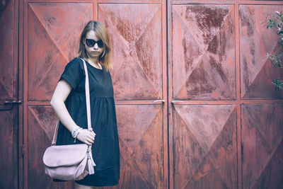 Woman with purse standing at entrance