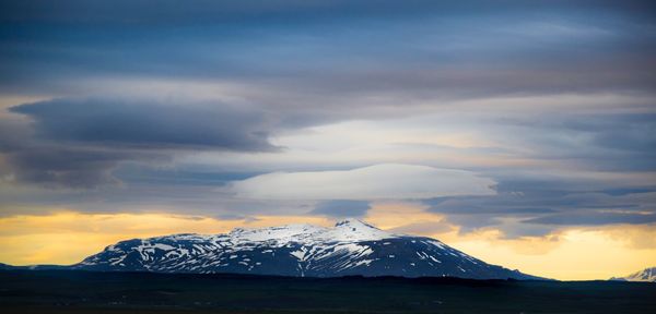 Scenic view of snowcapped mountains against sky during sunset