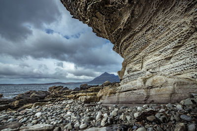 Scenic view of sea and mountains against sky