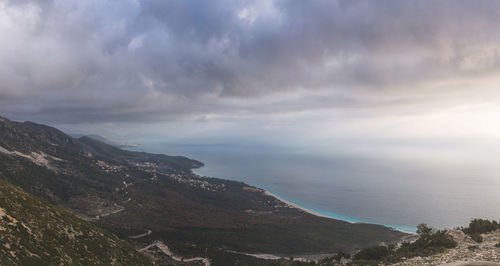 Scenic view of sea and mountains against sky