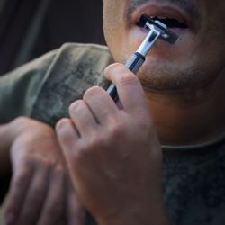 Close-up of man holding razor