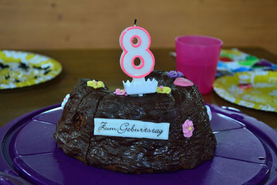 Close-up of birthday cake served on table