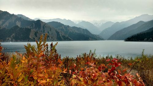 Scenic view of lake in front of mountains against sky