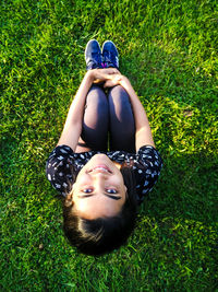 Portrait of young woman lying on grass