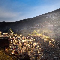 Illuminated cityscape against sky at dusk