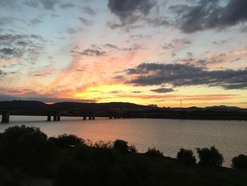 Scenic view of calm lake at sunset