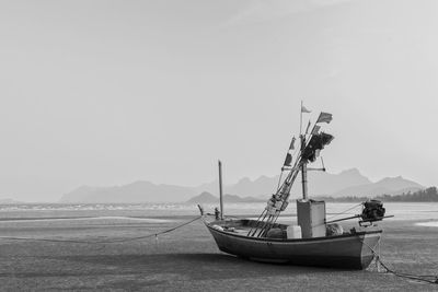 Small local fishing boats parked at low tide