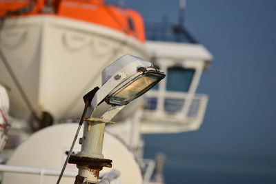 Close-up of ship moored on sea against clear sky, boatlights