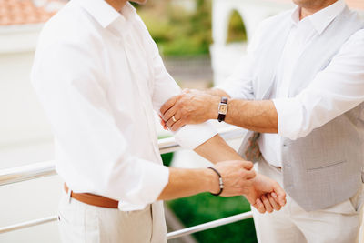 Midsection of couple holding hands