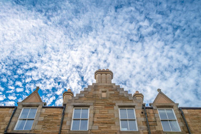 Low angle view of building against cloudy sky