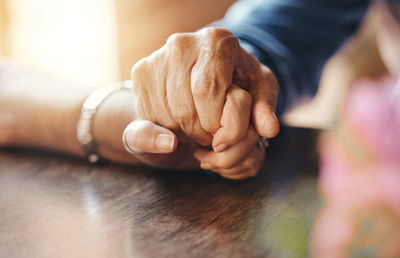 Cropped image of couple holding hands