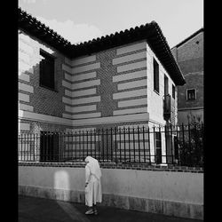 Rear view of people walking on built structure