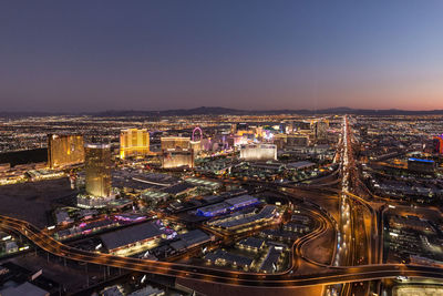 High angle view of illuminated buildings against sky at night