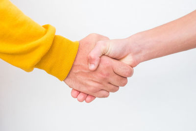 Close-up of hands over white background