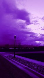 Road against cloudy sky at dusk