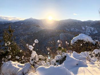 Scenic view of snowcapped mountains against sky during winter