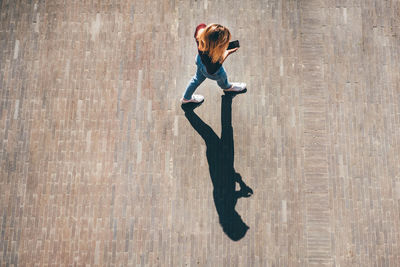 Low angle view of woman standing on hardwood floor