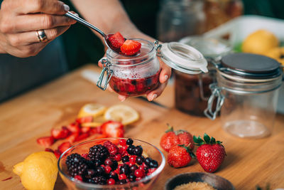 Midsection of man with fruits on table