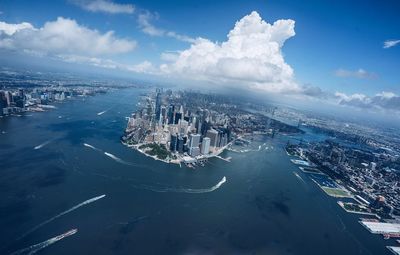 Aerial view of cityscape and river against sky