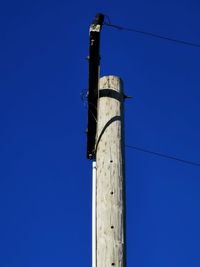 Low angle view of tower against clear blue sky