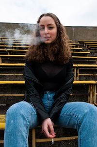 Portrait of woman sitting on bench