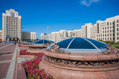 Buildings in city against blue sky