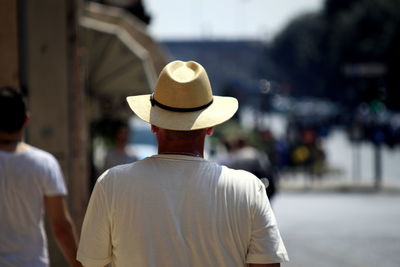 Rear view of man in front of hat