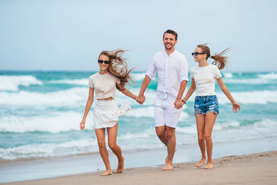 Friends standing at beach