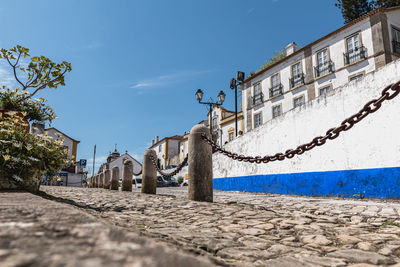 Street amidst buildings in city against sky