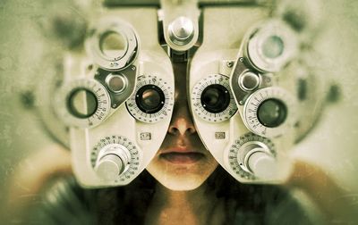 High angle view of eye test equipment over teenage girl
