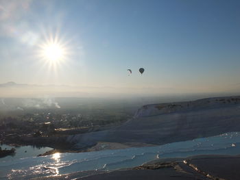 View of hot air balloon flying over water