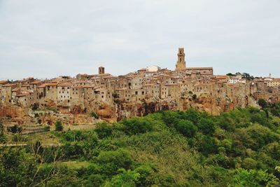 Old buildings in town against sky at pitigliano