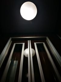 Low angle view of illuminated lamp