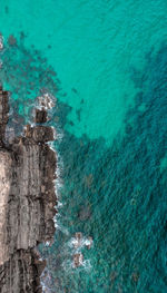 High angle view of rocks by sea