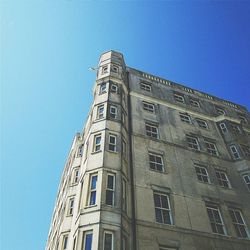 Low angle view of building against clear blue sky