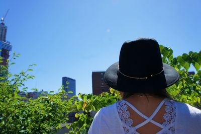 Rear view of man against blue sky