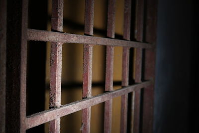 Close-up of rusty metallic gate prison bars