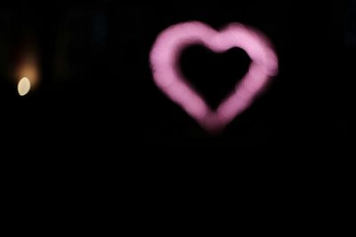 Close-up of light bulb over black background