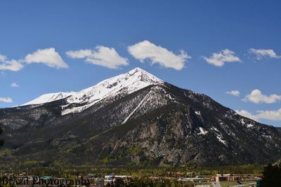 Scenic view of snowcapped mountain against cloudy sky