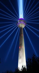 Low angle view of illuminated ferris wheel against sky at night