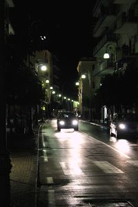 Wet illuminated street during rainy season at night