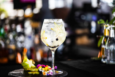 Tonic gin beverage with fresh fruits and spices