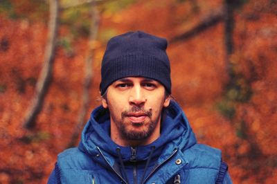 Portrait of young man in forest during autumn