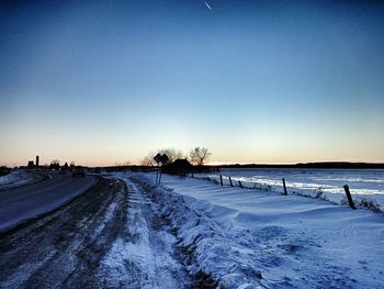 Scenic view of snow covered field against clear sky