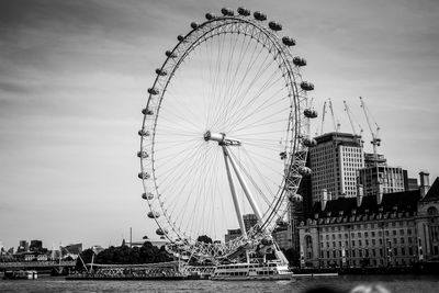 Ferris wheel in city against sky